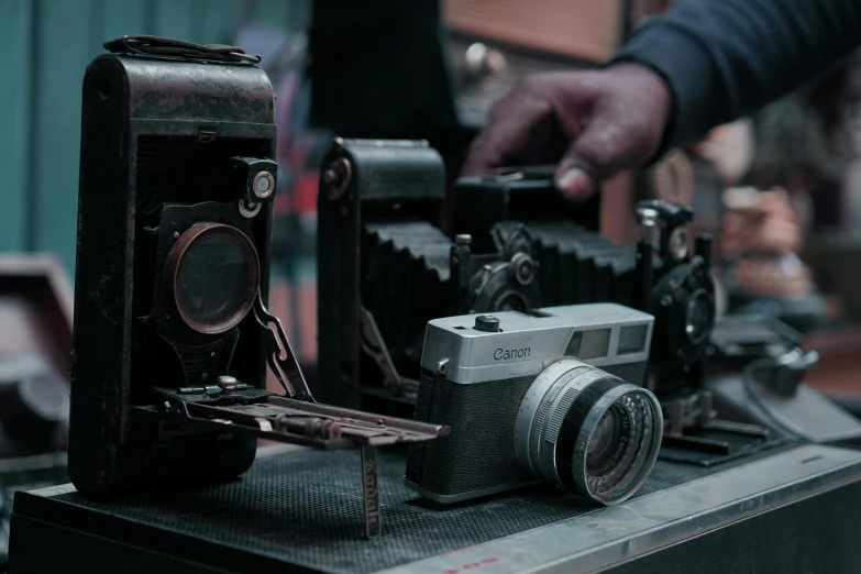 two cameras on top of one another on a table