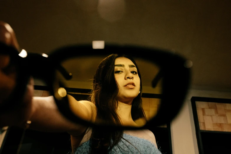 a woman looking out the side mirror of her car