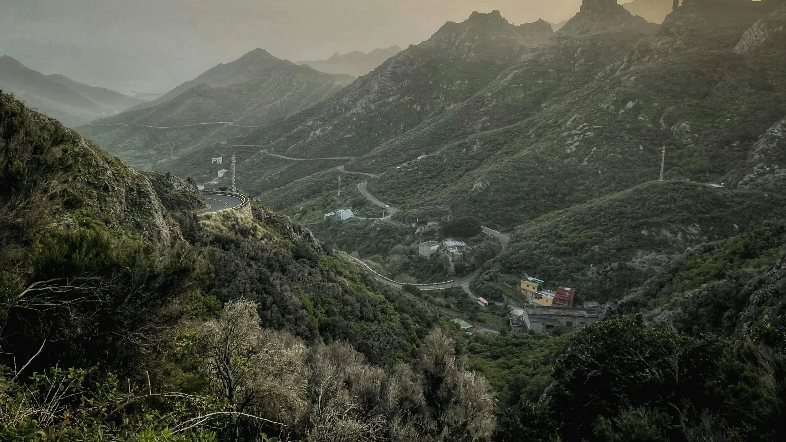 an image of a mountain view with a village in the distance