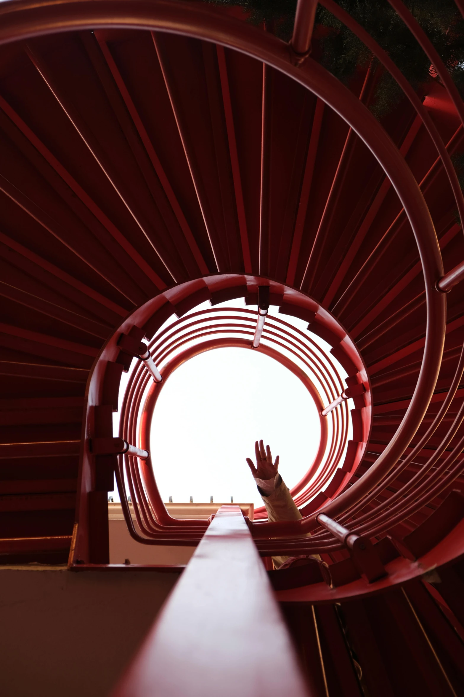 a person holding their hands up toward a round structure