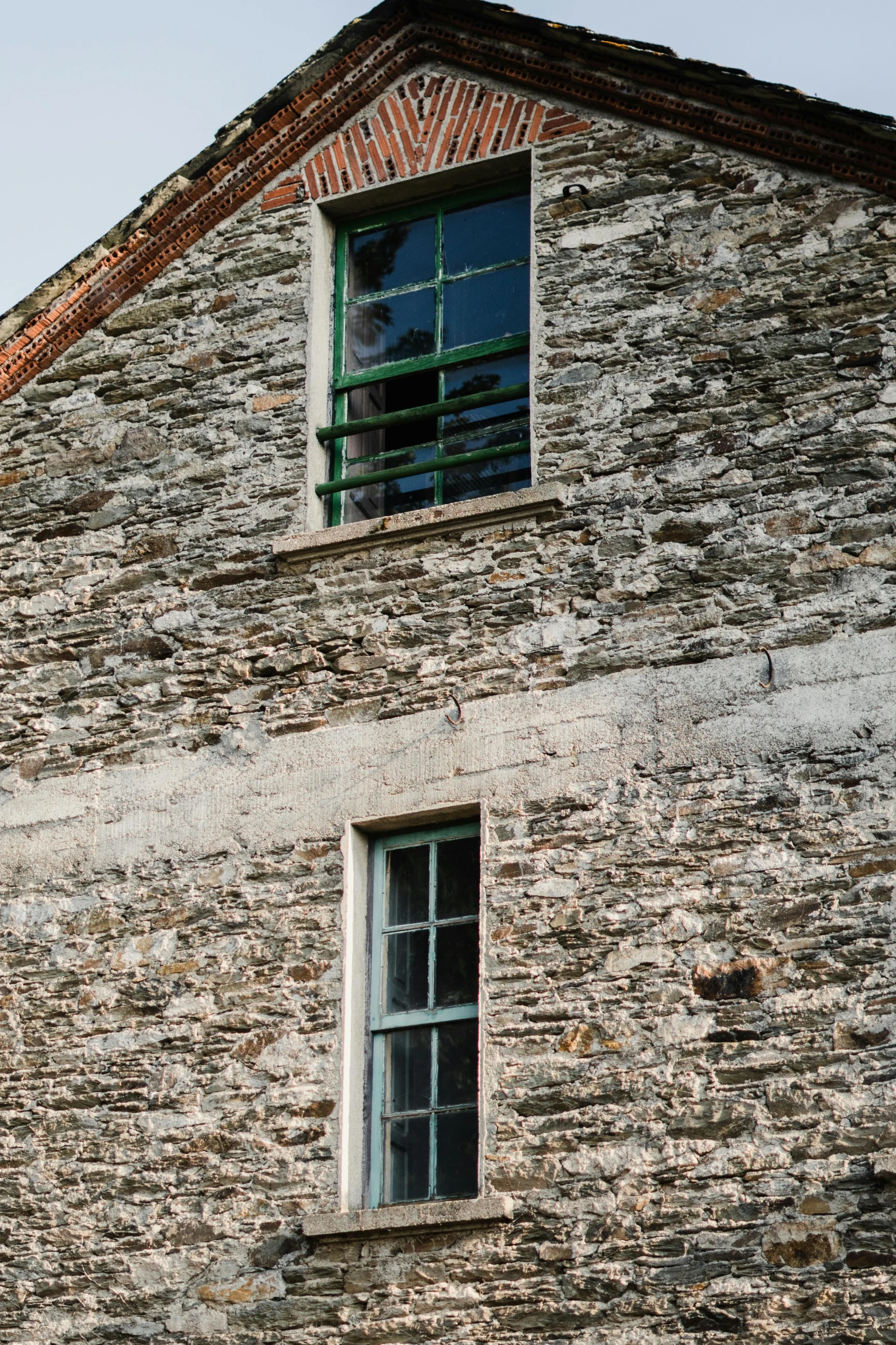 a brick building with two windows on the side