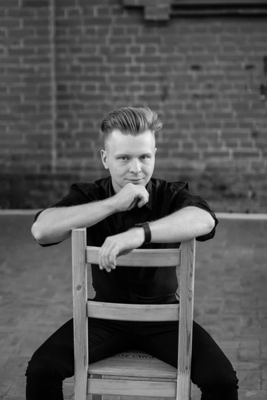 a man sitting in a chair and looking at the camera