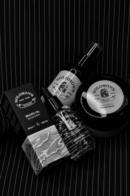 a man is looking at two hair products on a black and white striped surface