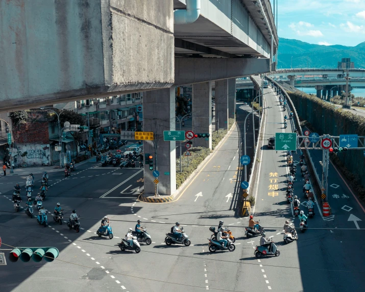 several motorcycle traffic drives down a large city road