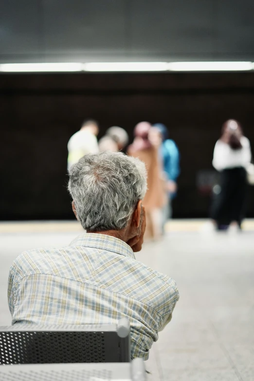 a man sitting on top of a bench