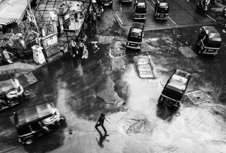 a street scene in black and white showing the cars in the water