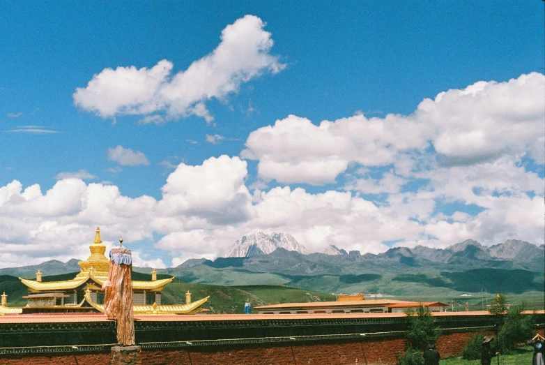 a large building with a huge hill in the background