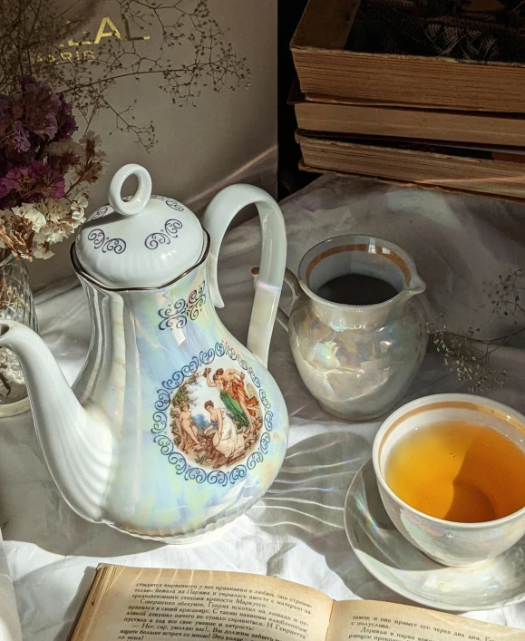 tea is being served near an open book