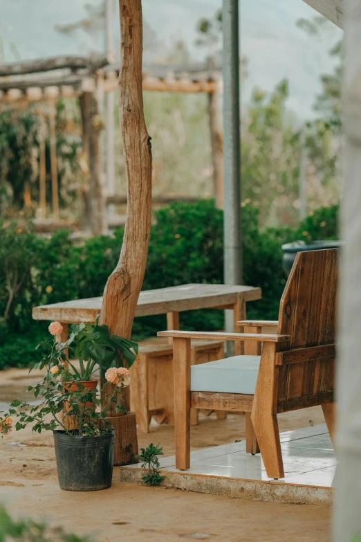 the outdoor patio table has some potted plants next to it