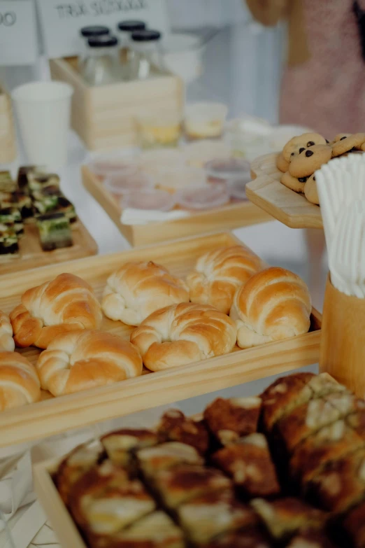 an assortment of pastries displayed on wooden platters