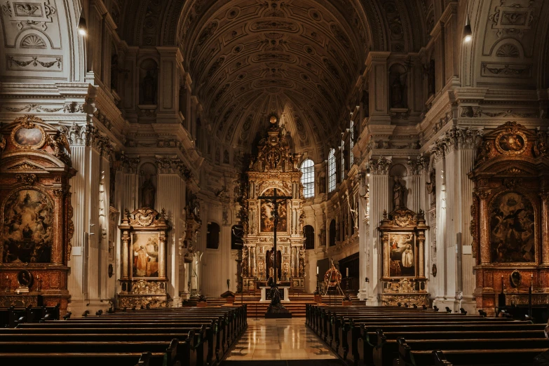 inside view of cathedral with many pews and intricate gold decorations