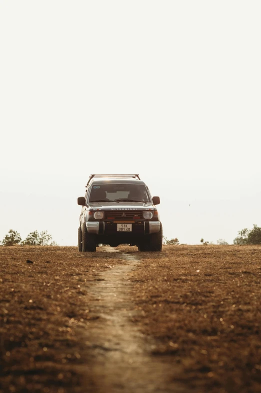 a car is parked in a field with it's roof down