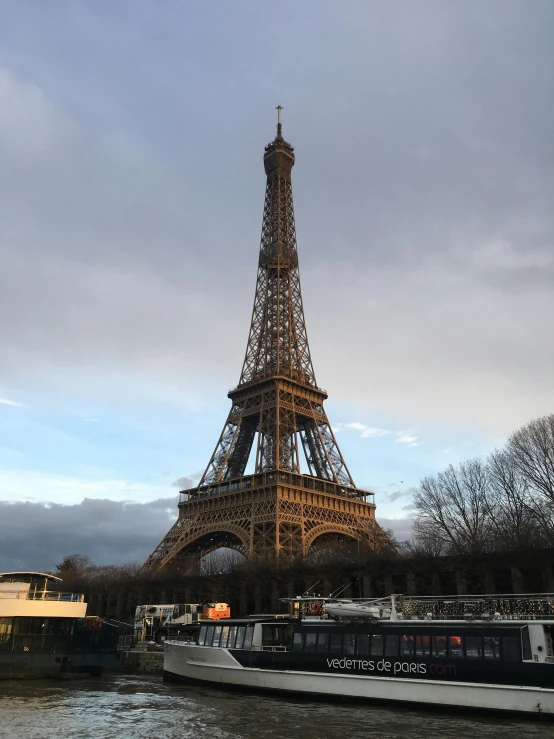 the tour bus is passing in front of the eiffel tower