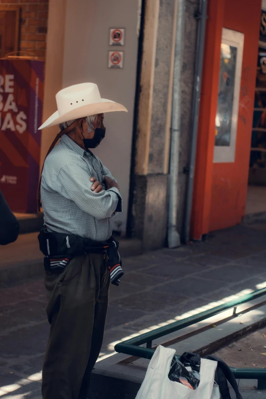 a man with a hat, backpack, and some white bags