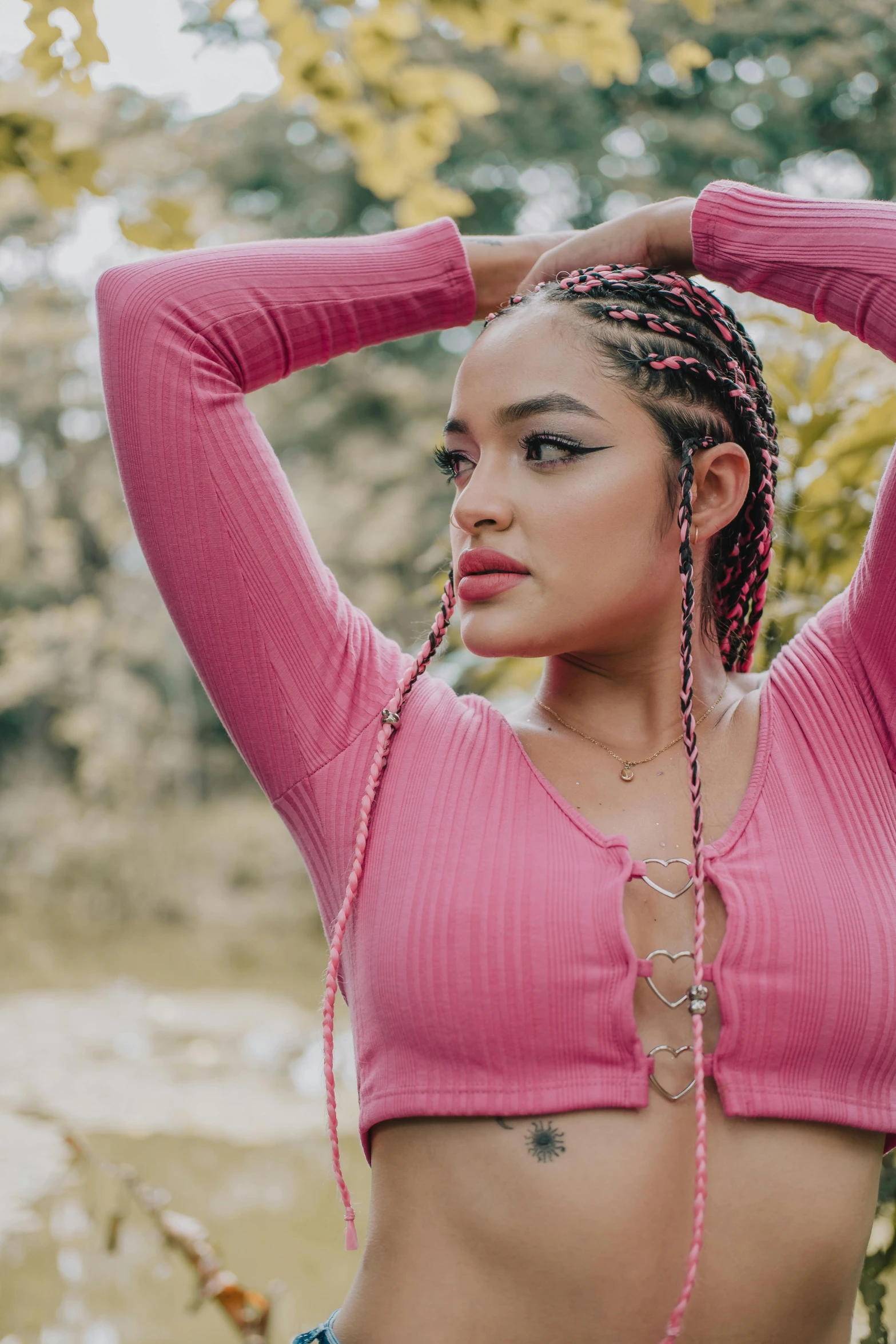 a close up of a woman wearing a pink top and beads