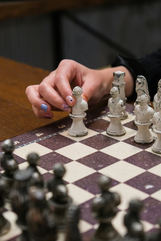 a person playing a game of chess on a table