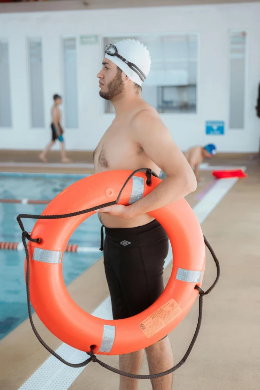 a man wearing goggles holding an life preserver