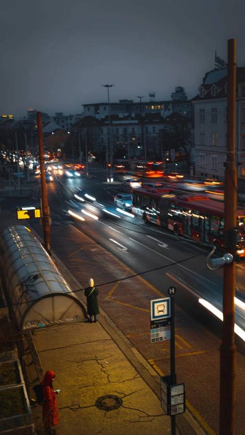 city busses in motion on a road at night