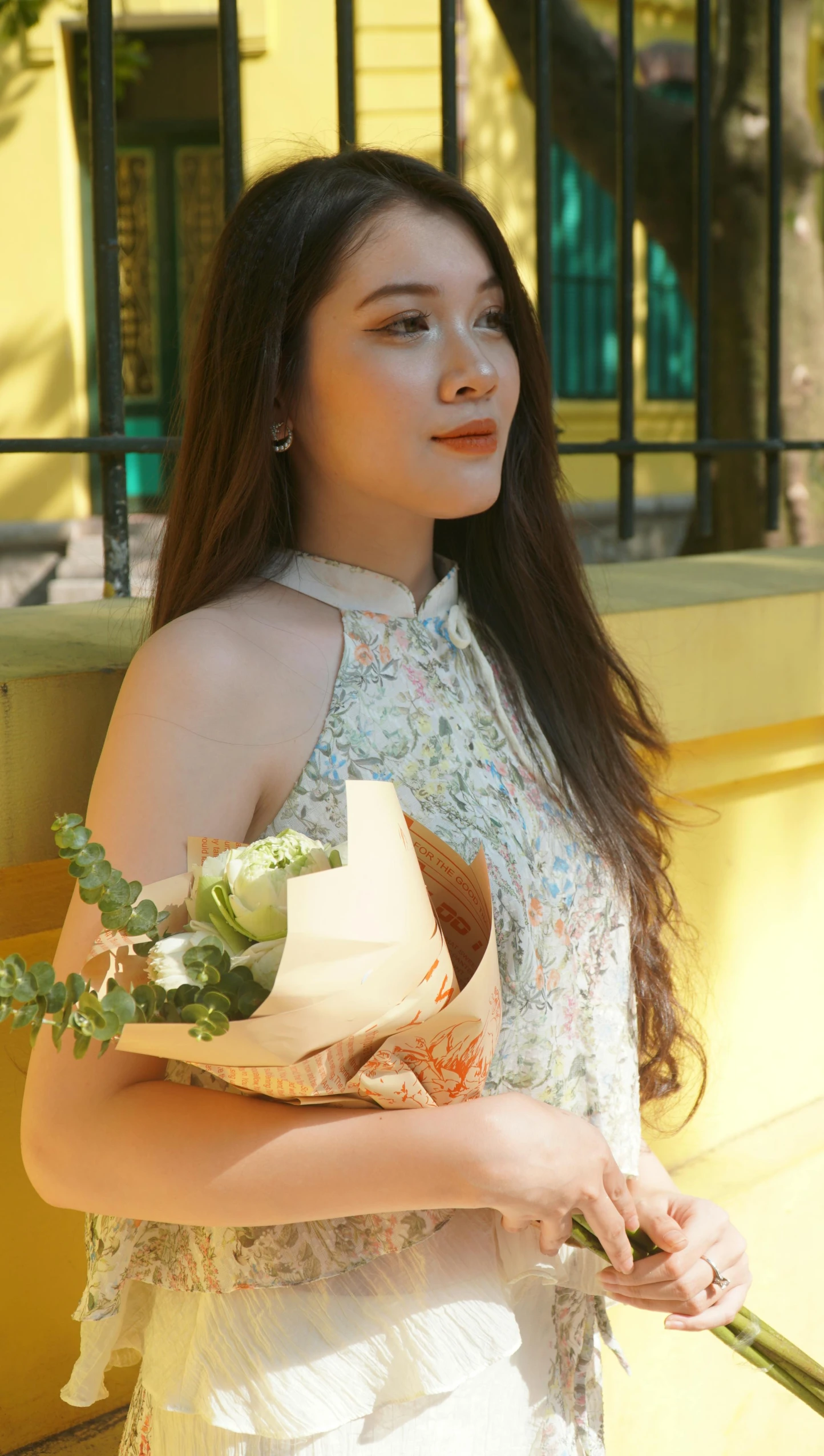 a woman with long hair holding a bouquet of flowers