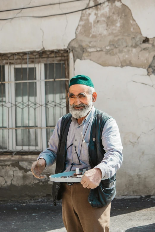 an old man has his hands wide open and a knife in his hand