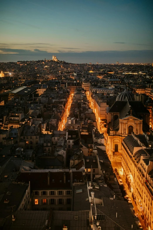 aerial view of cityscape at night with lights on buildings