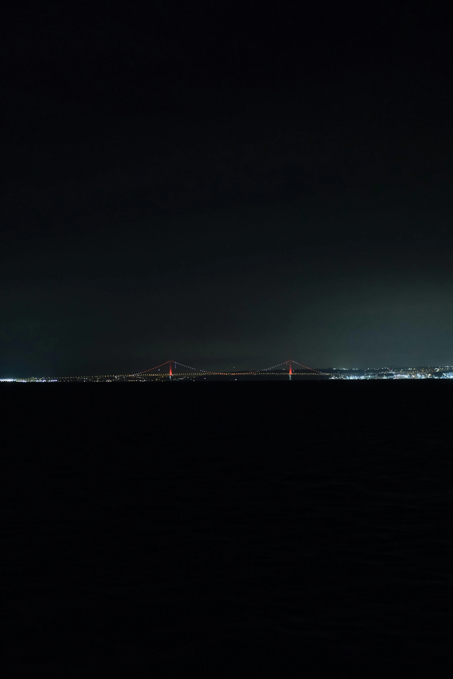 a large body of water at night with city lights on it