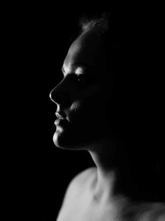 the profile of a  woman with makeup and hair in black