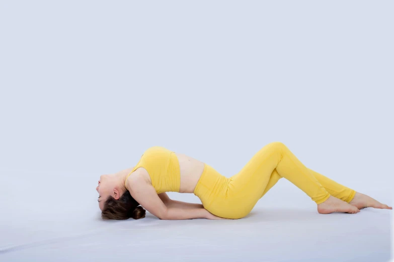 the person is wearing a yellow outfit on her stomach