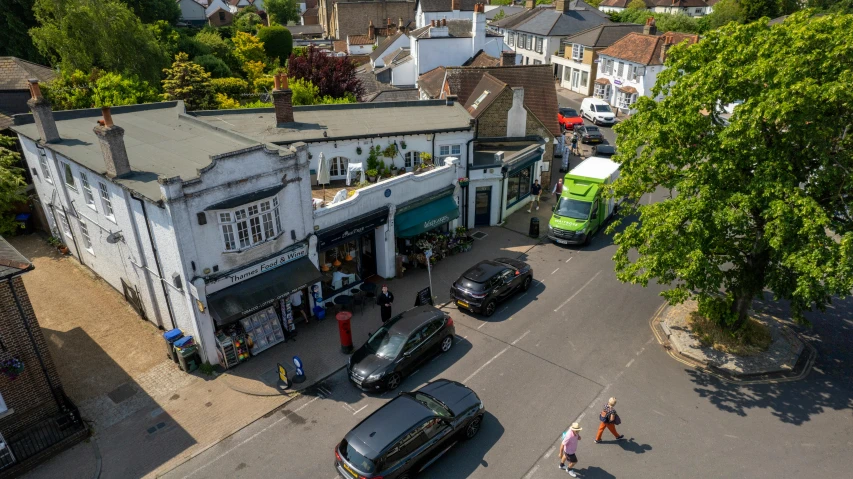 several cars parked at an intersection with a green bus