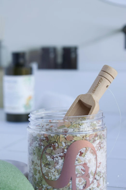 a mortar and wooden mallet resting in a jar