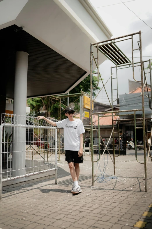 the young man is walking through the gate