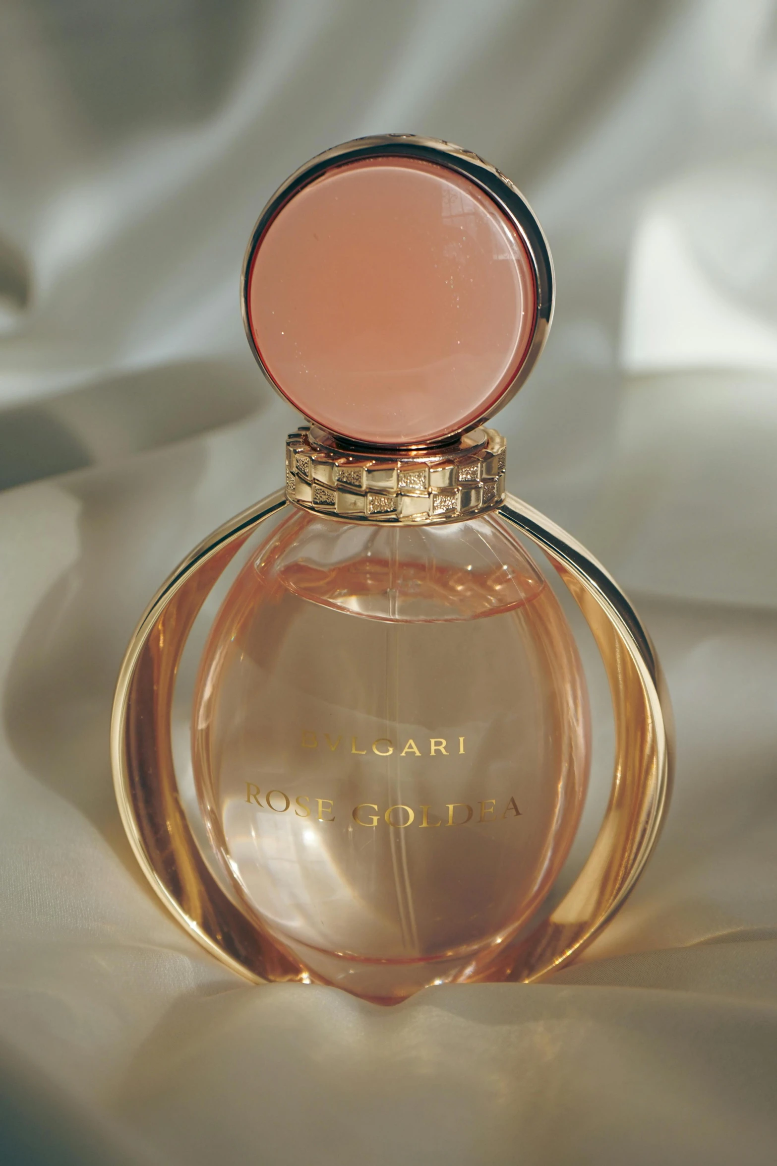 the open lid of a small perfume bottle