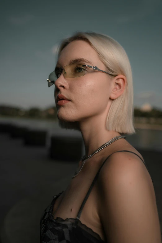 woman with glasses and black dress posing for a portrait