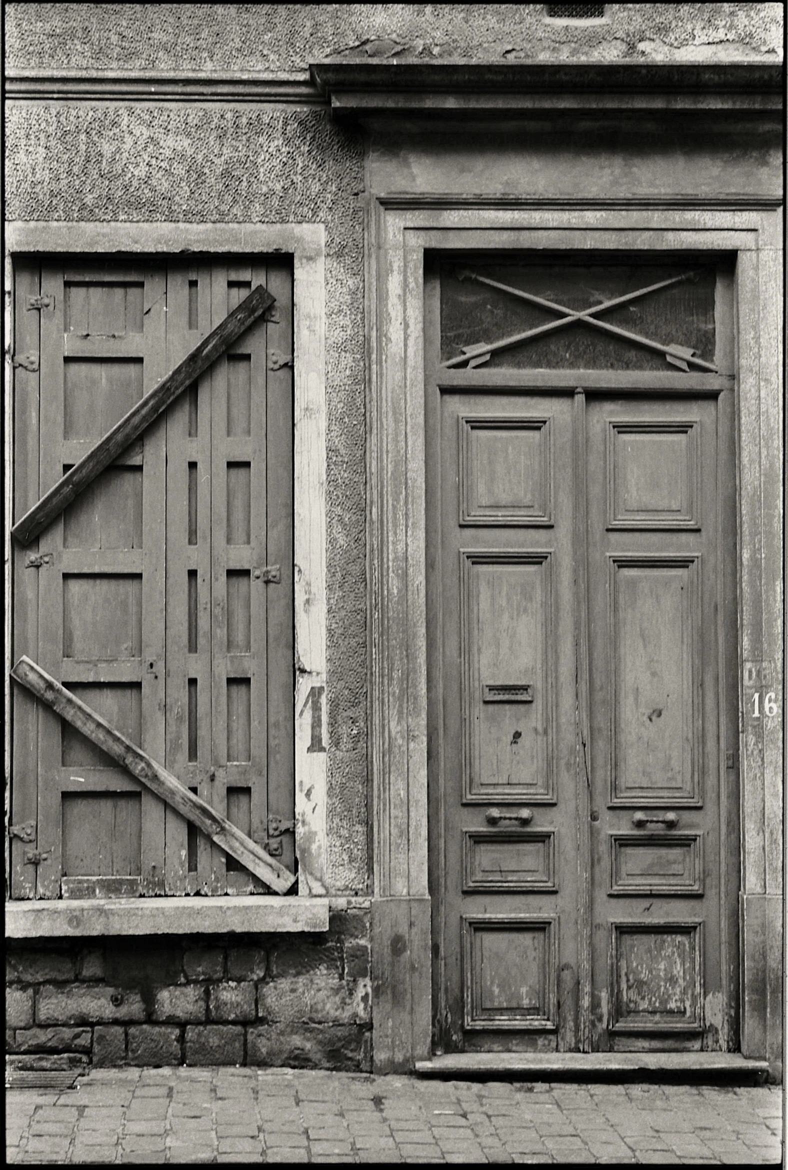 an old doorway sitting next to a closed door