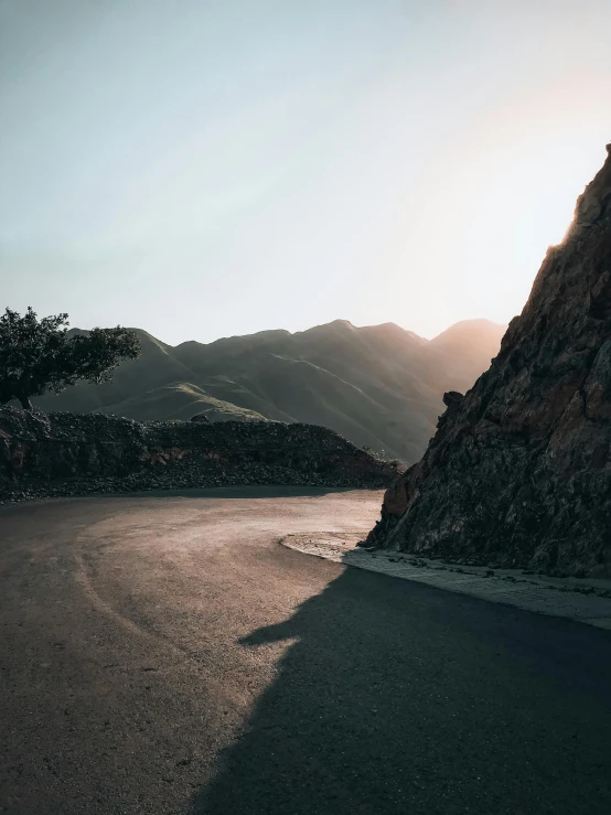 a road near some hills in the distance