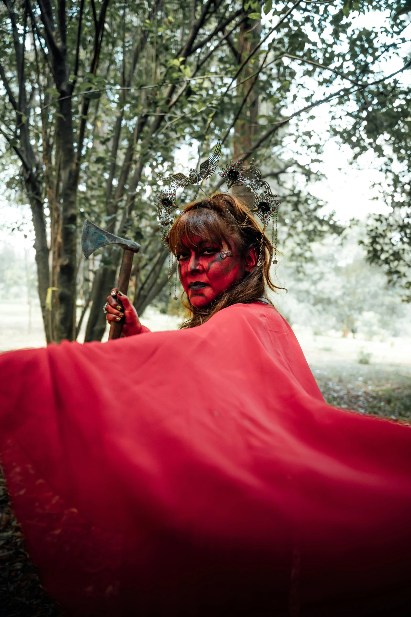 a woman in red is covering herself with a red cloth