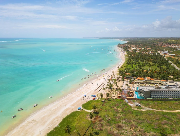 the beach in front of a tropical resort