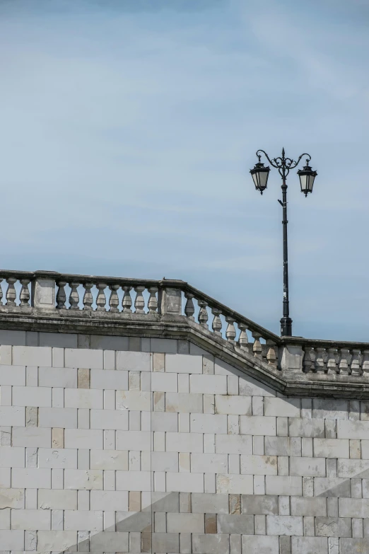 an image of a light pole by some concrete