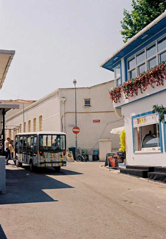 a small tour bus parked in front of a building