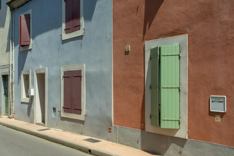 multiple colors of small buildings on the side of the street