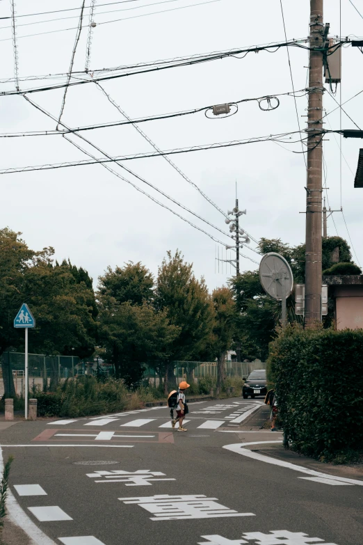 a man crossing the road on a bike