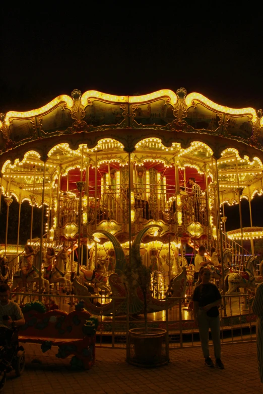 a merry go round with carousel lights and people