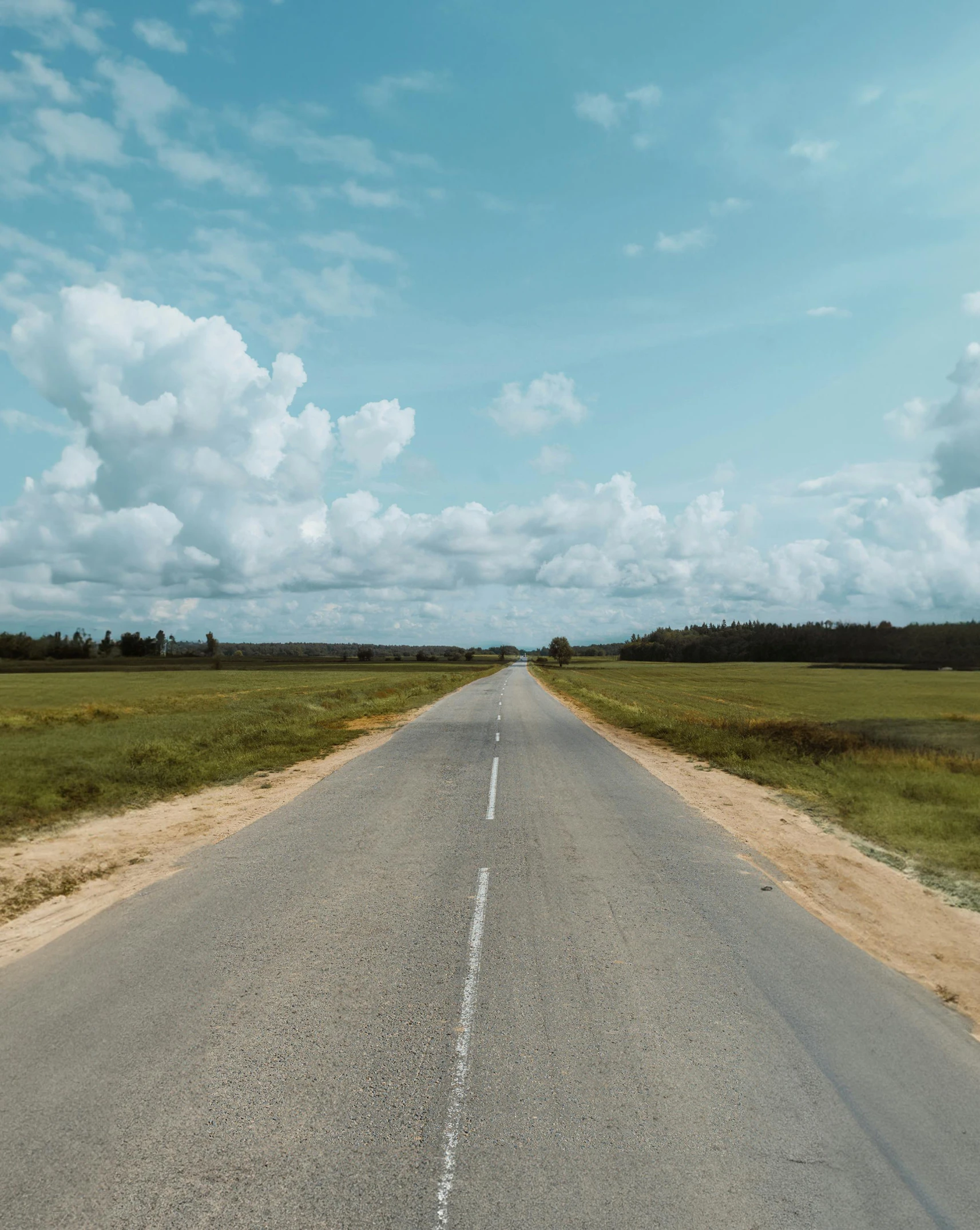 a picture of an open empty highway that has white lines