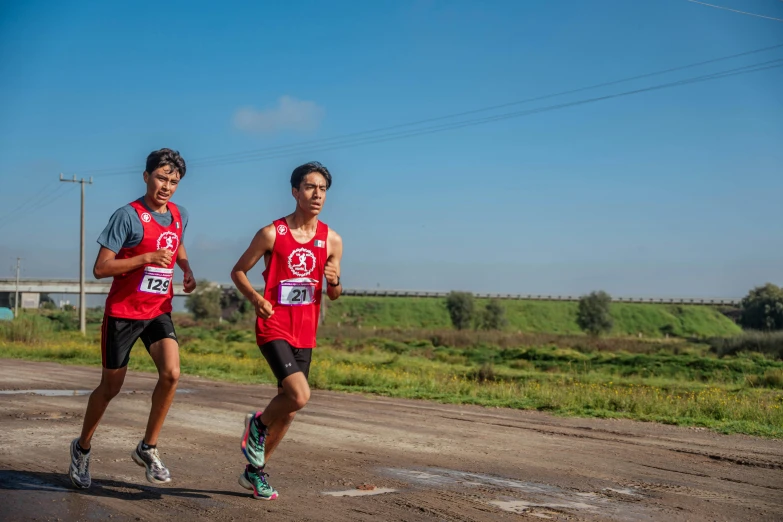 the two people are running in their shirts and their shoes