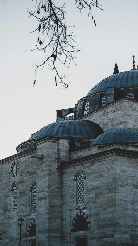 an old stone church building is shown with an elegant blue dome