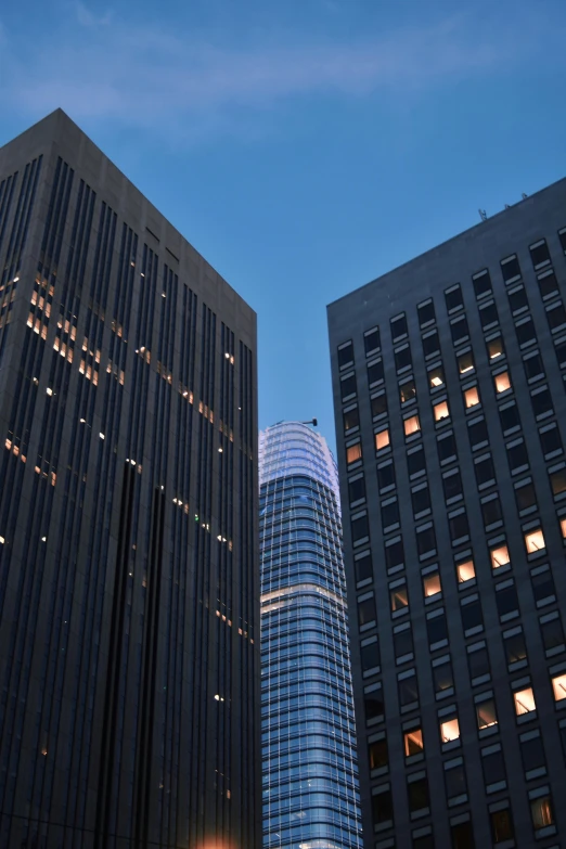 very tall buildings are lit up with night lights