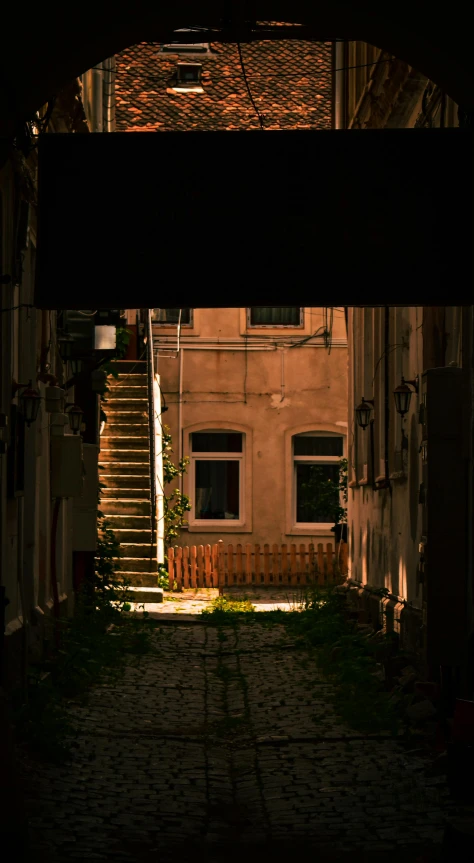 an entrance to a building with a street lamp at the end