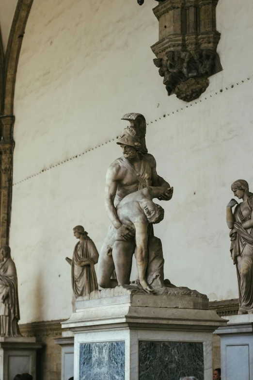 an ancient statue on display next to other statues