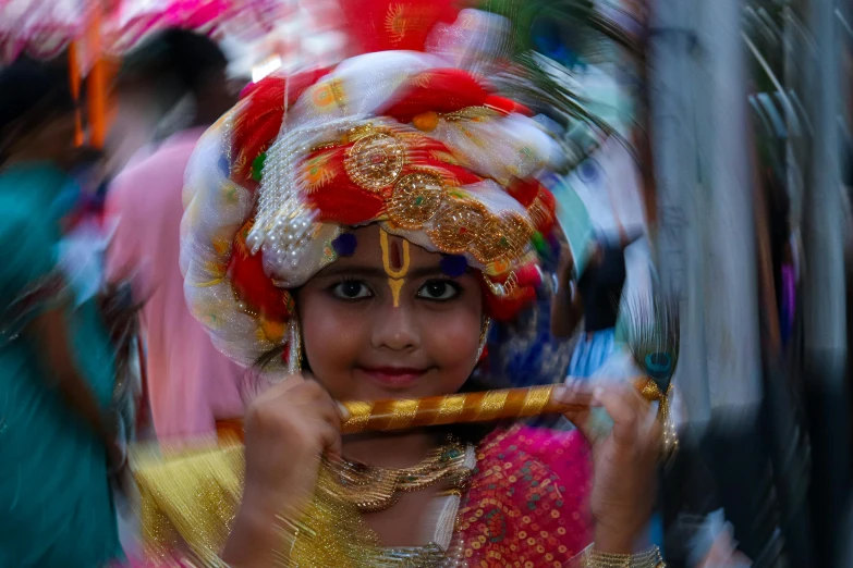 an indian woman with makeup on holding a stick