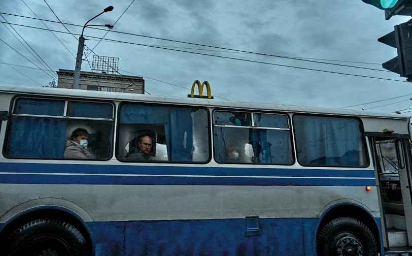 a couple of men are riding on a bus